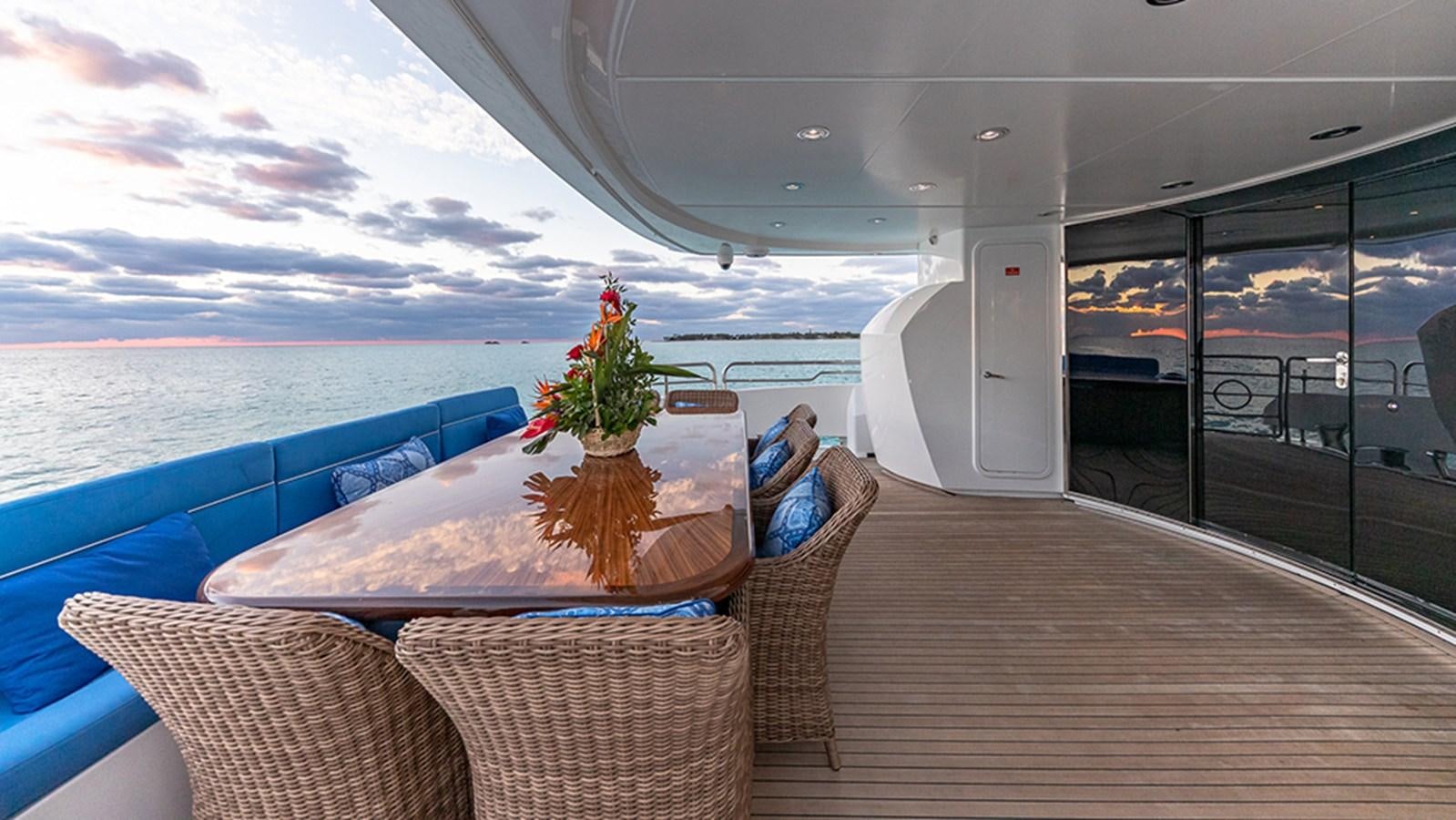 a deck with a large pool and a large window aboard KEFI Yacht for Sale