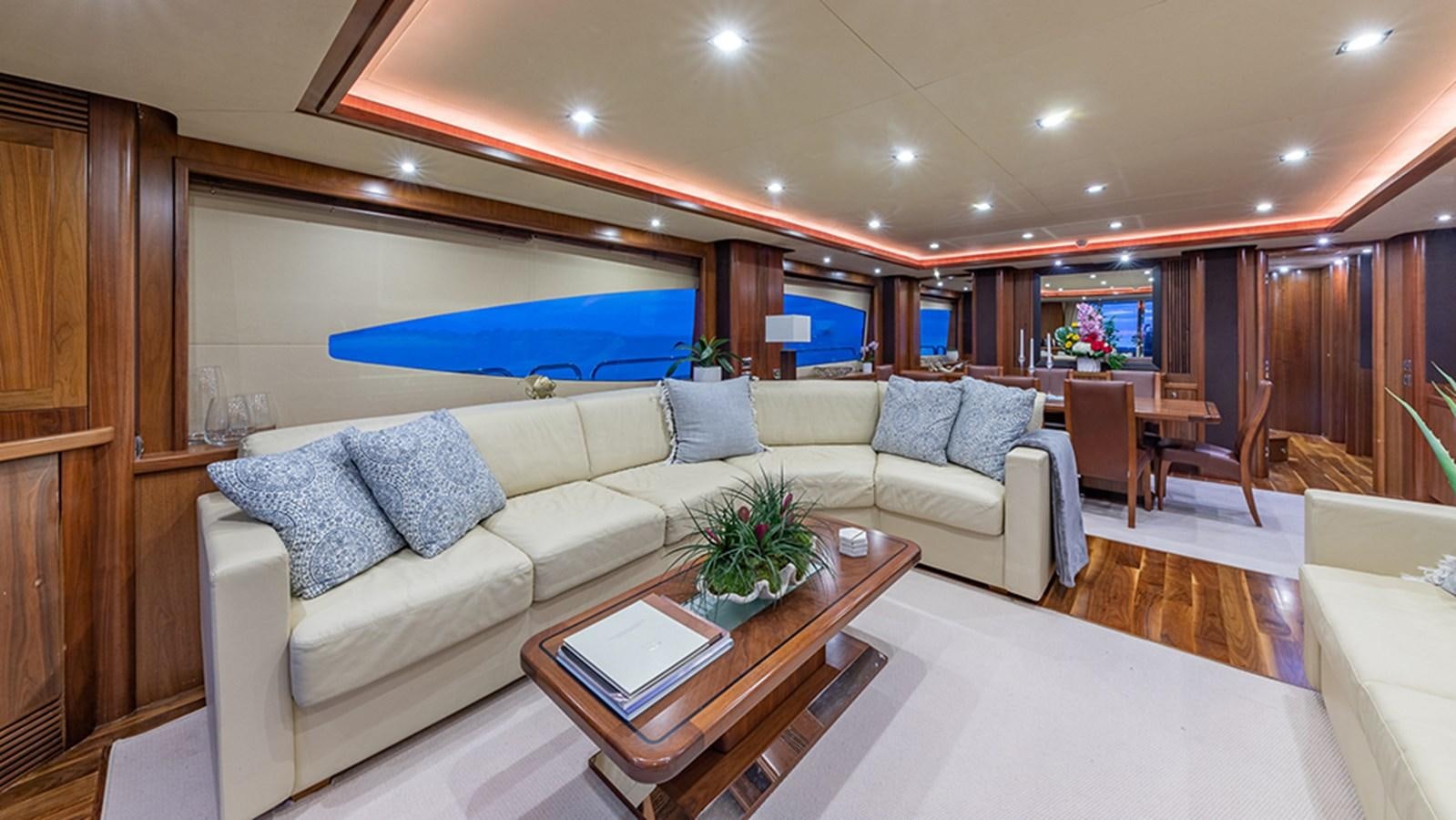 a living room with a couch and a table aboard KEFI Yacht for Sale