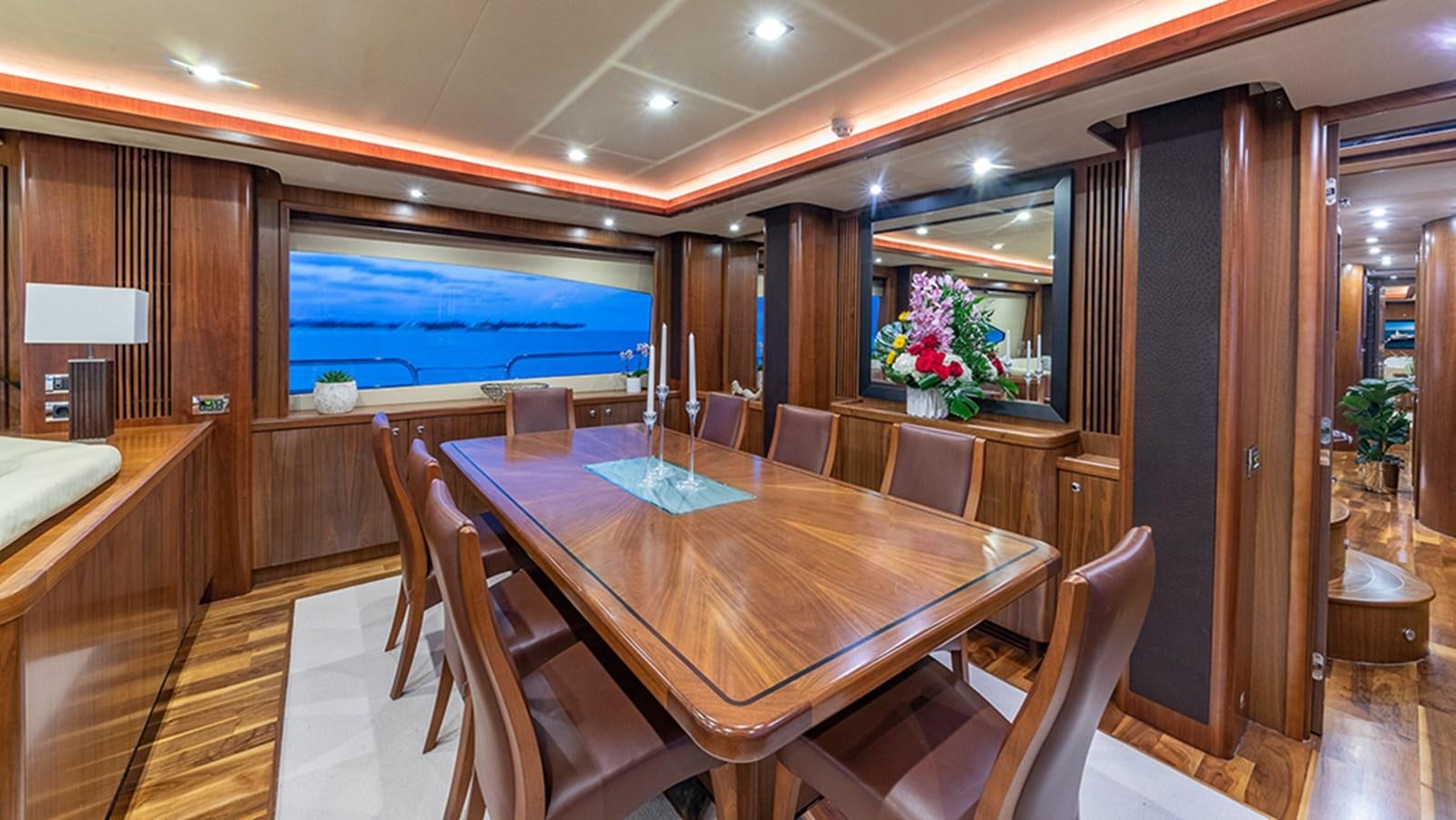 a room with a table and chairs aboard KEFI Yacht for Sale