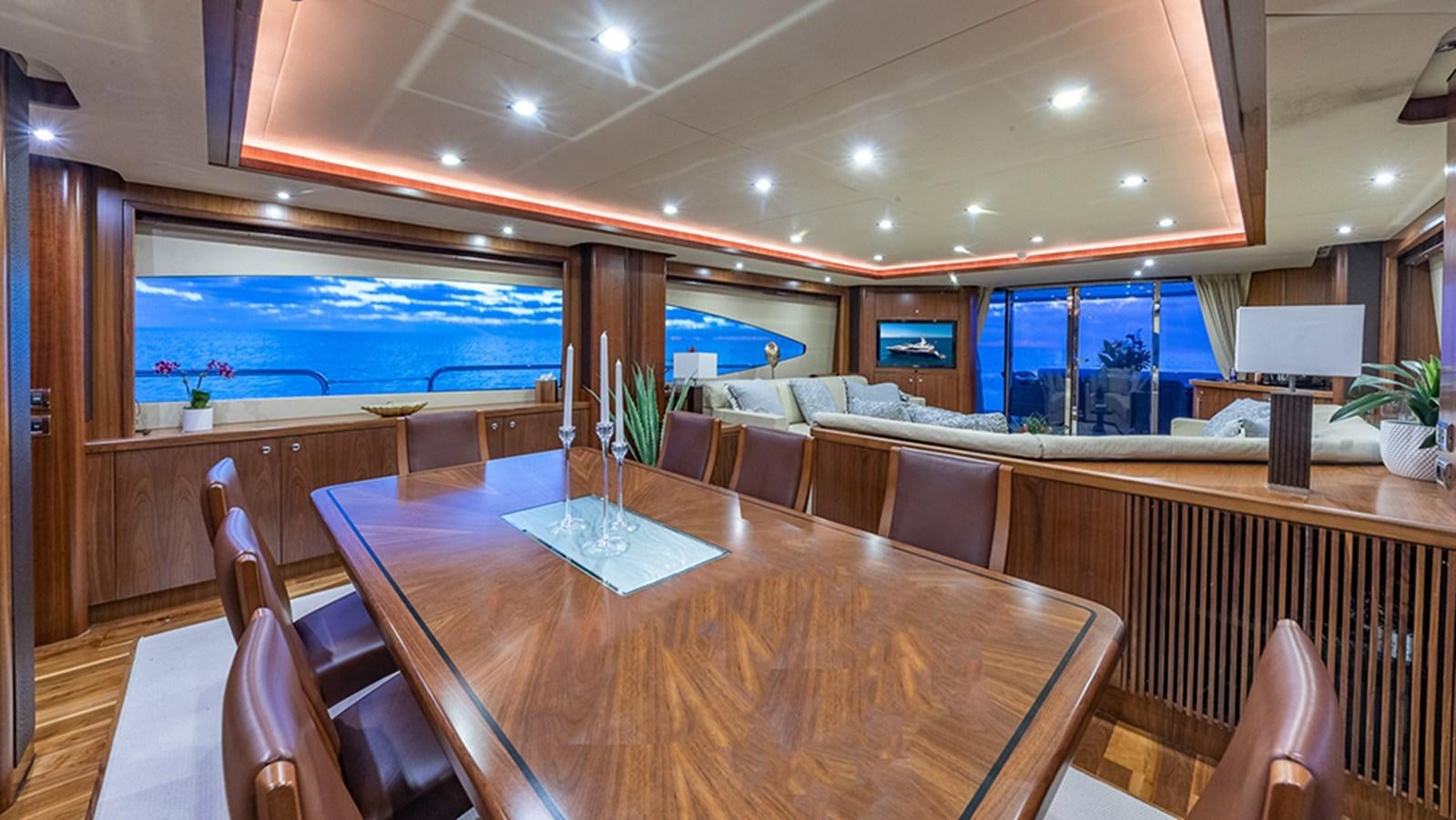 a large room with tables and chairs aboard KEFI Yacht for Sale