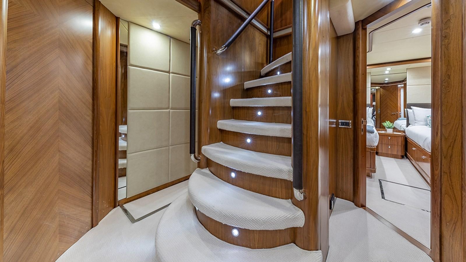 a large bathroom with a wood staircase aboard KEFI Yacht for Sale