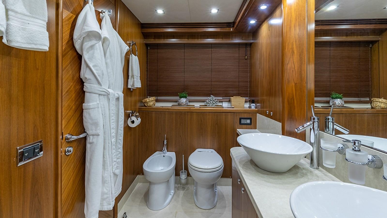 a bathroom with a sink toilet and a bathtub aboard KEFI Yacht for Sale