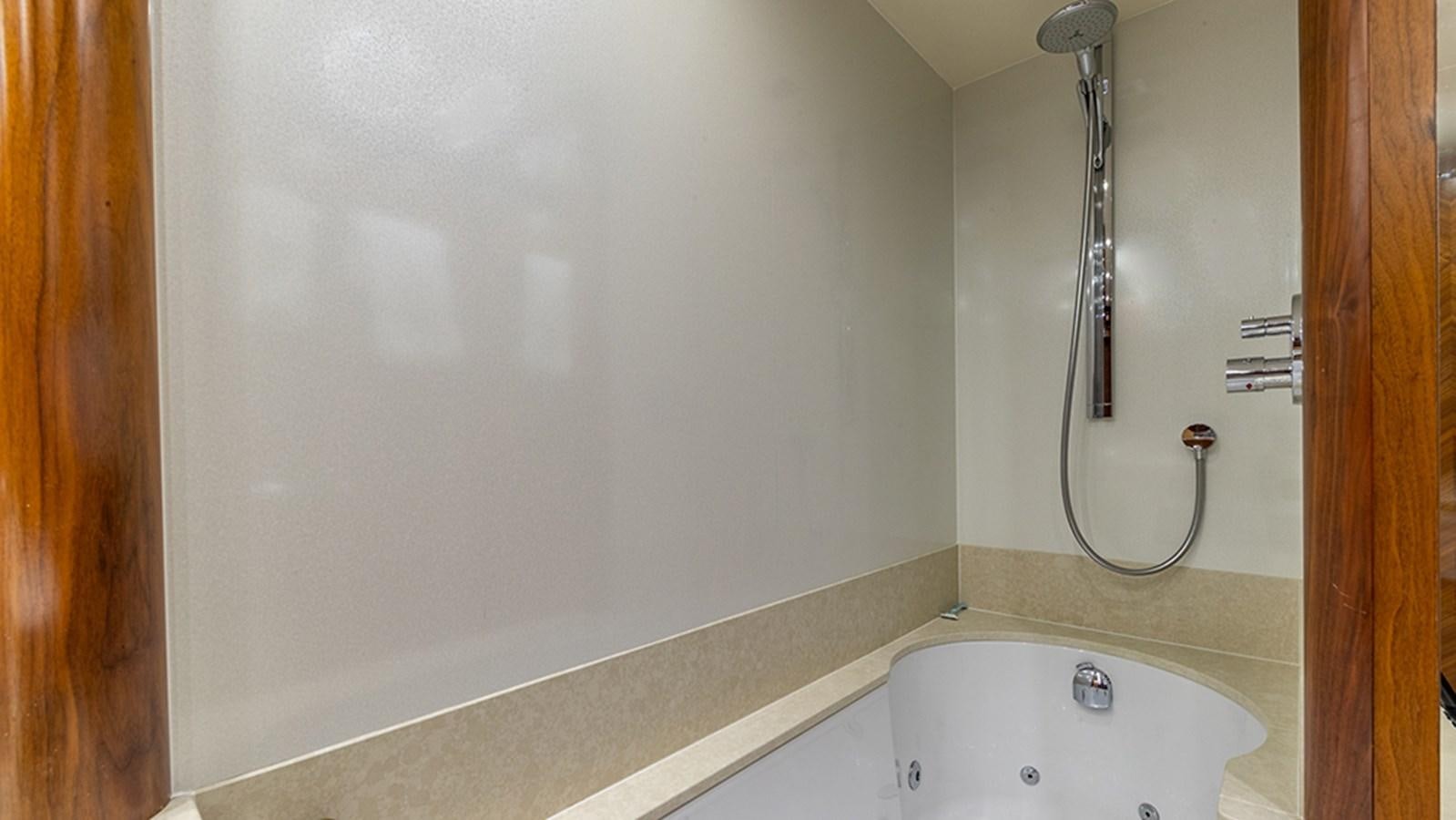 a bathtub and shower unit aboard KEFI Yacht for Sale