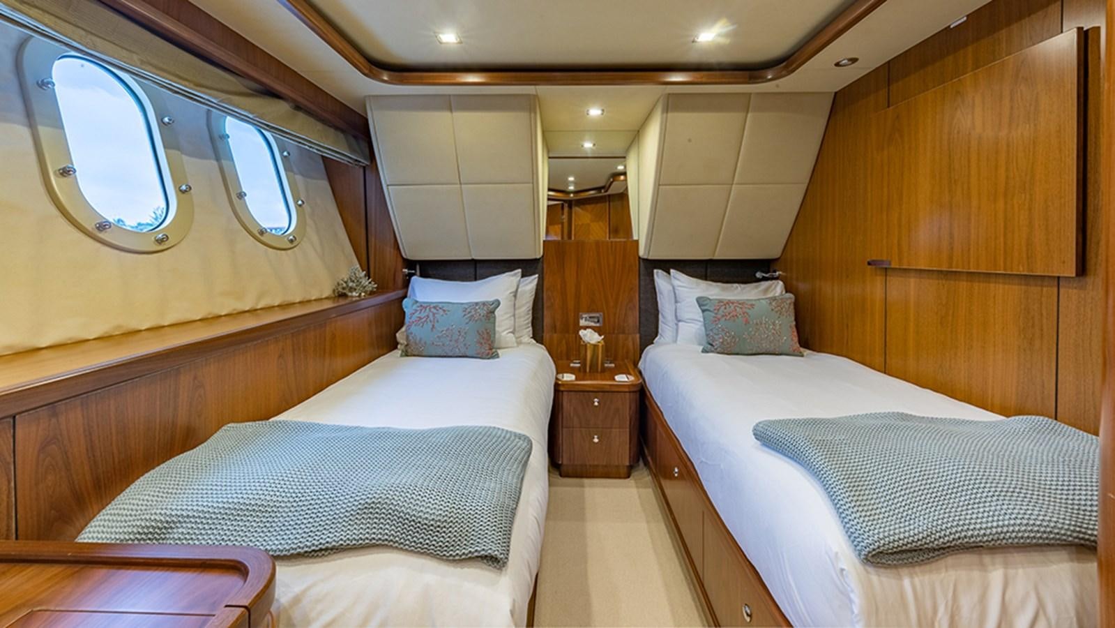 a room with two beds aboard KEFI Yacht for Sale