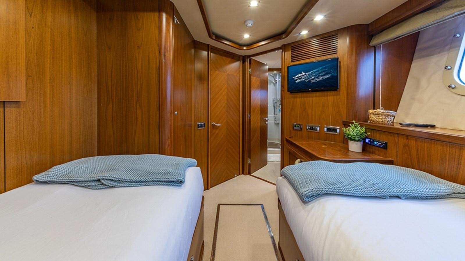 a room with a bed and a tv aboard KEFI Yacht for Sale