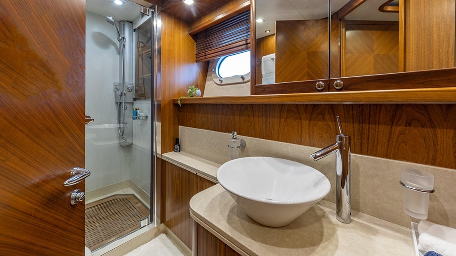 a bathroom with a sink and a mirror aboard KEFI Yacht for Sale