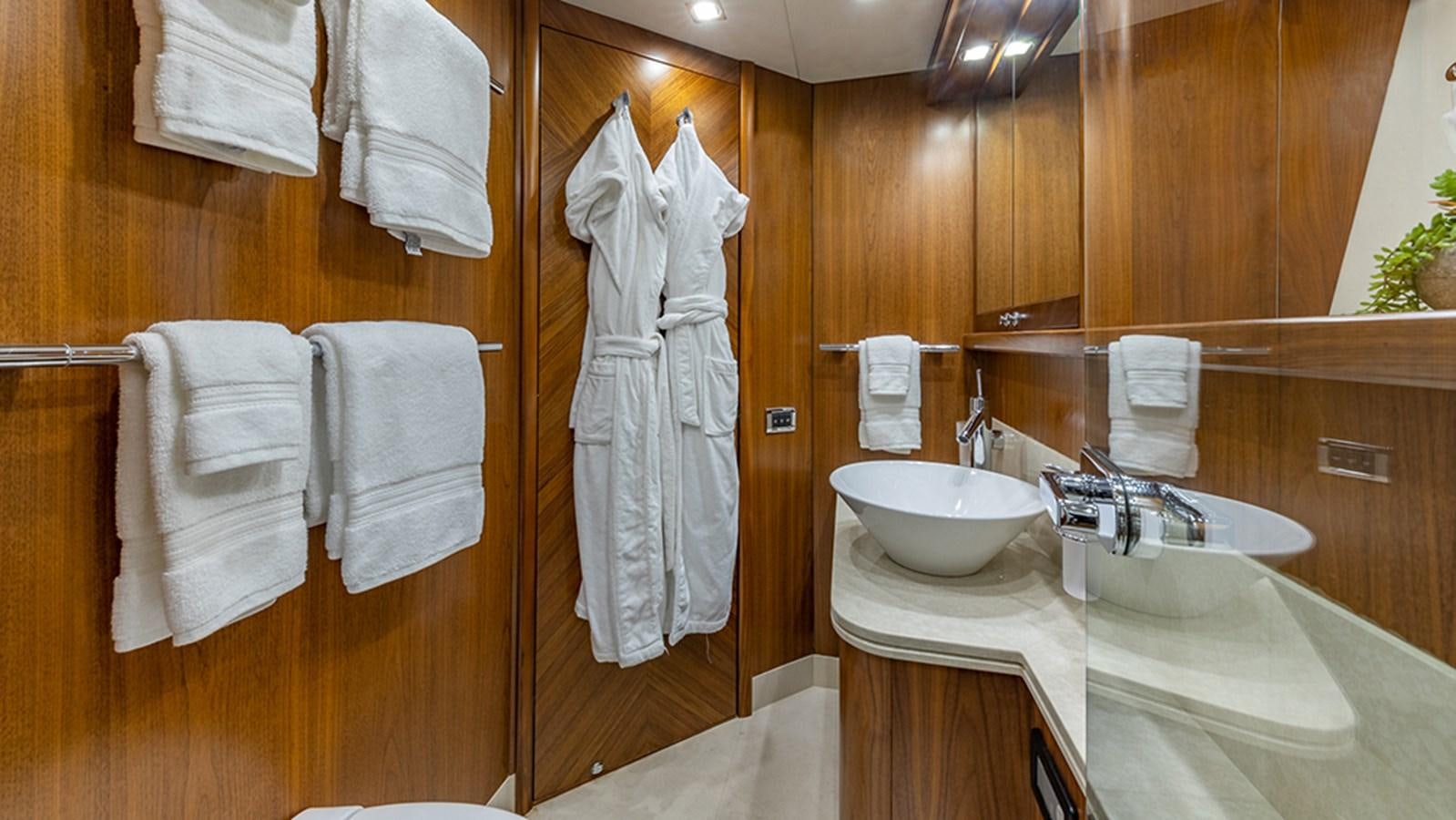 a bathroom with a sink and towels aboard KEFI Yacht for Sale