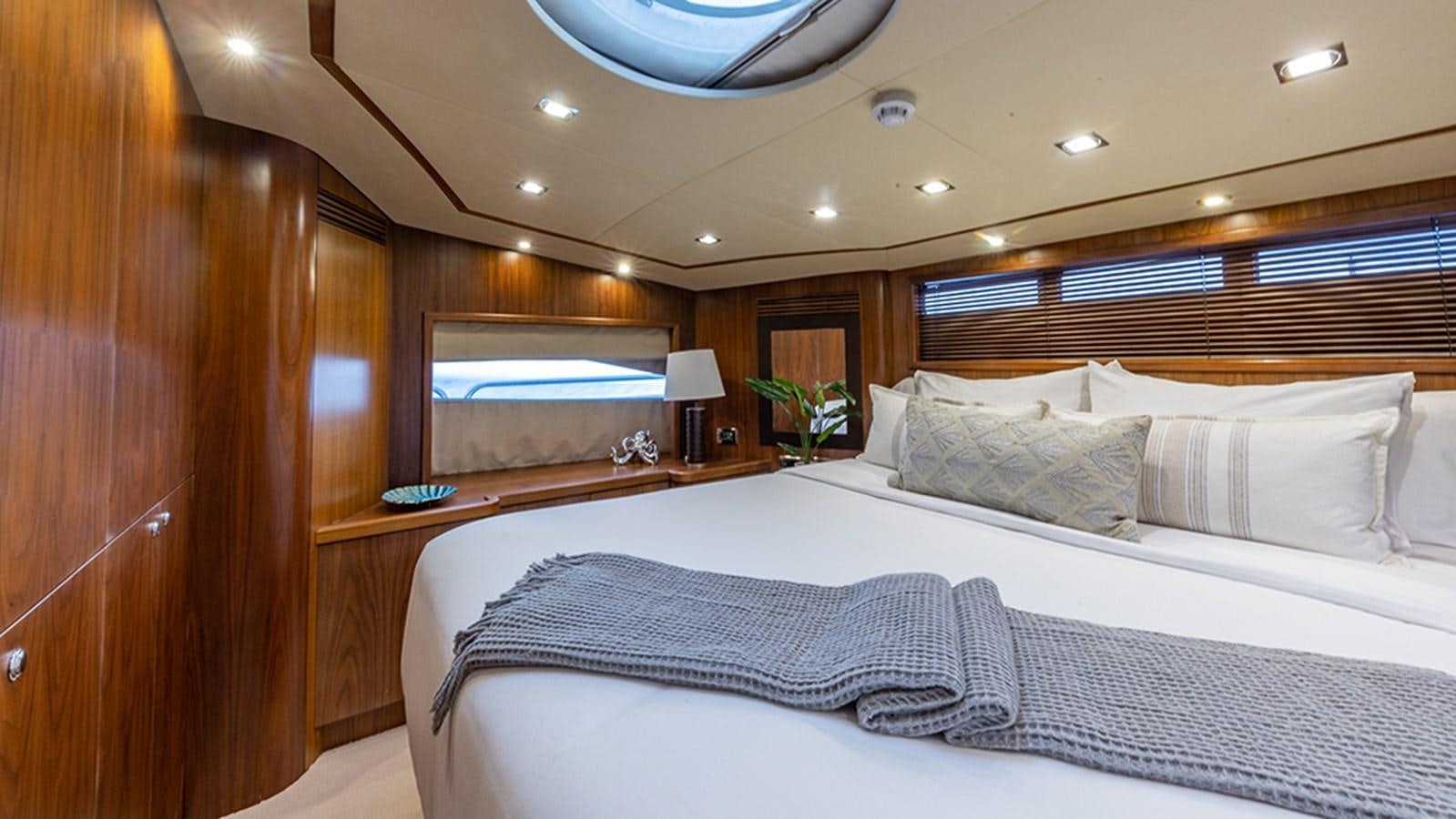a room with a bed and a television aboard KEFI Yacht for Sale