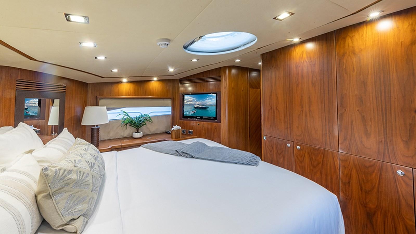 a room with a bed and a television aboard KEFI Yacht for Sale
