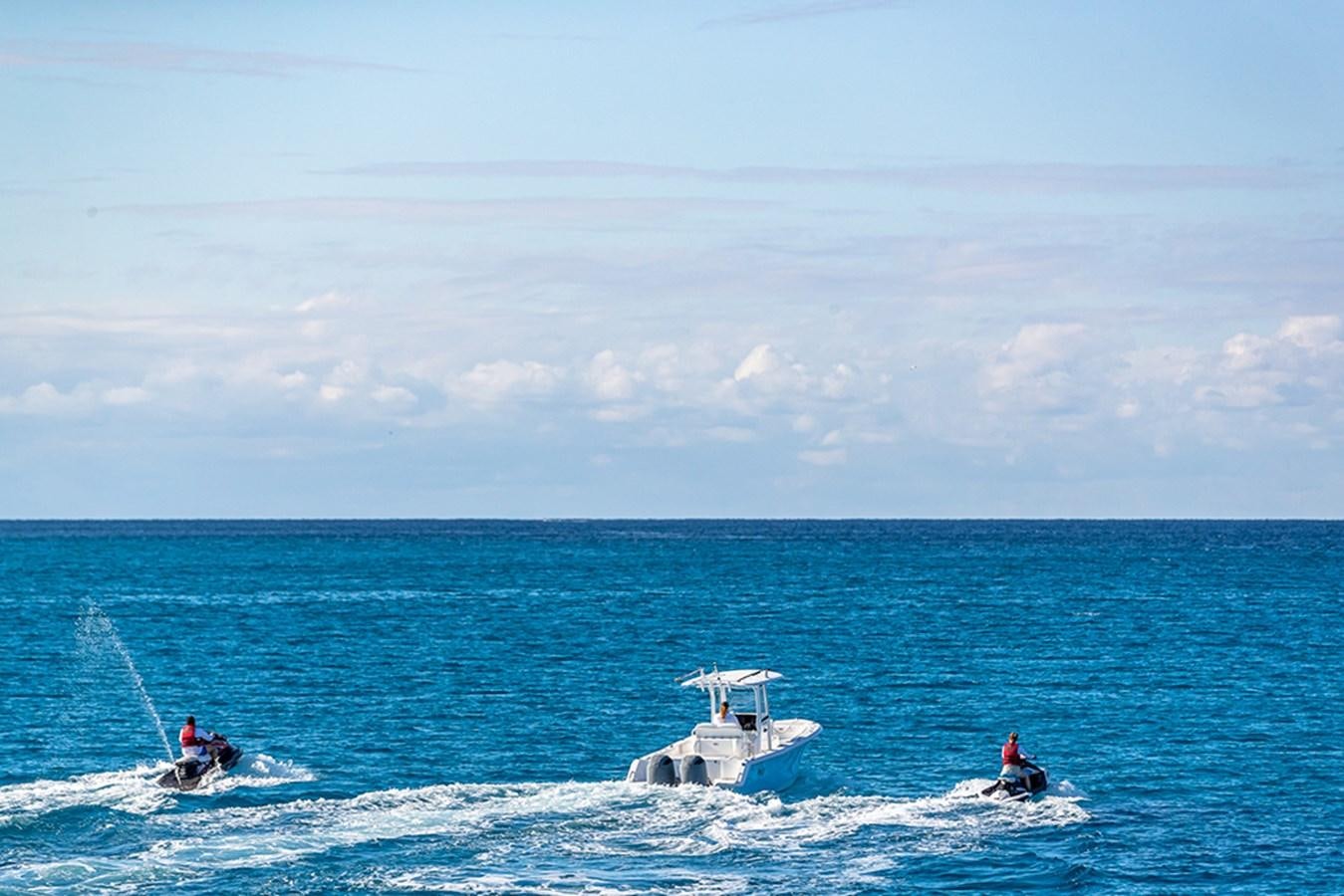 a group of people surfing in the sea aboard KEFI Yacht for Sale