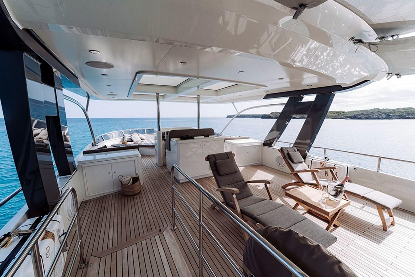 a boat with a deck and chairs aboard LAS NINAS Yacht for Sale