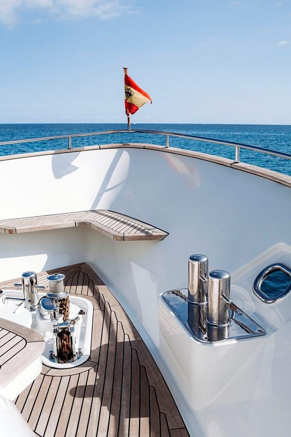 a boat with a flag on the front aboard LAS NINAS Yacht for Sale