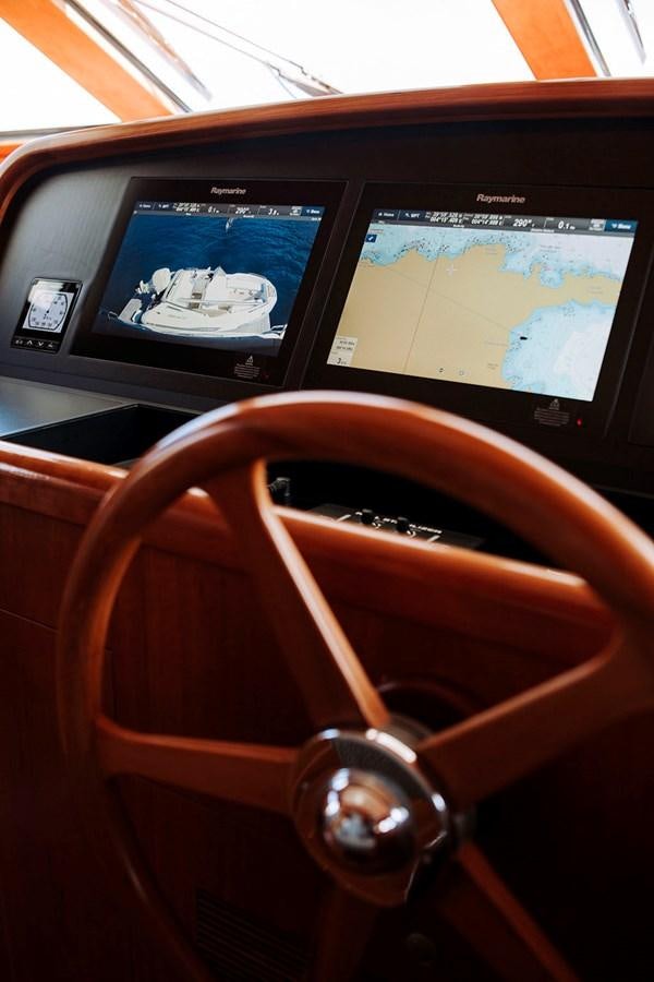 a steering wheel and dashboard of a vehicle aboard LAS NINAS Yacht for Sale