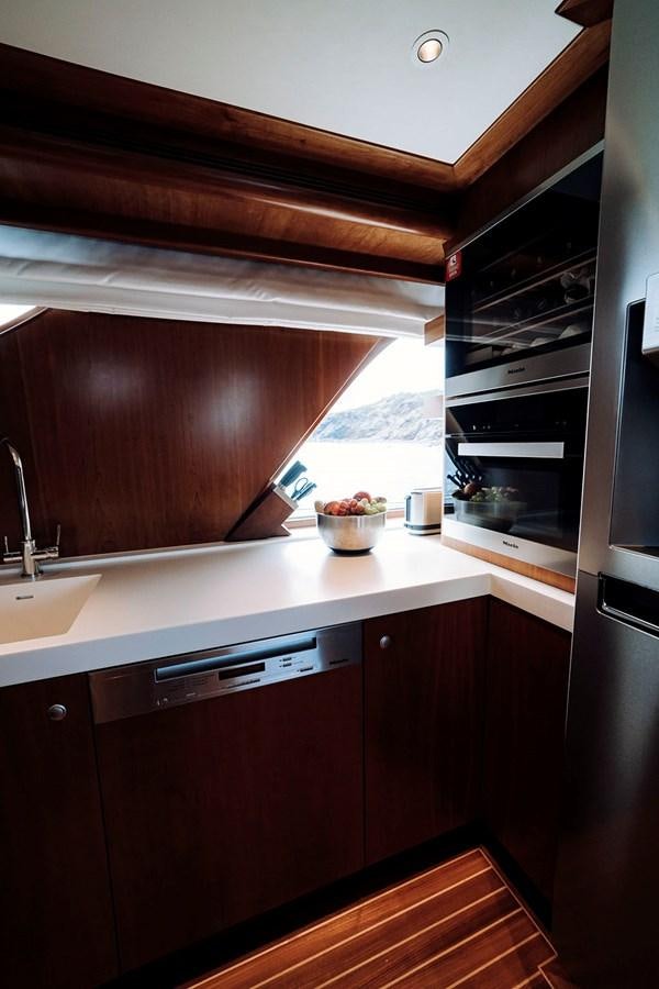 a kitchen with a sink and a stove aboard LAS NINAS Yacht for Sale