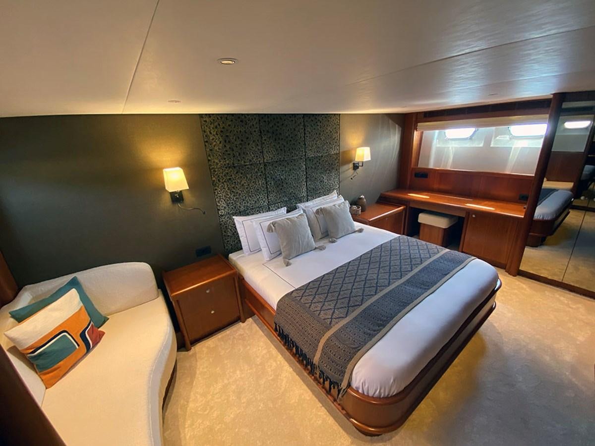 a bedroom with a bed and a dresser aboard LAS NINAS Yacht for Sale