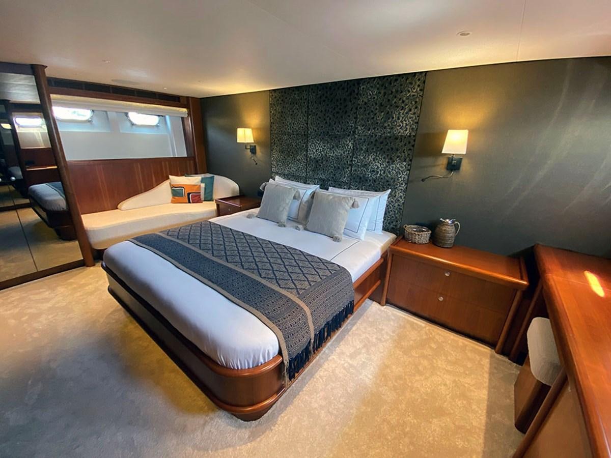 a bedroom with a bed and a mirror aboard LAS NINAS Yacht for Sale