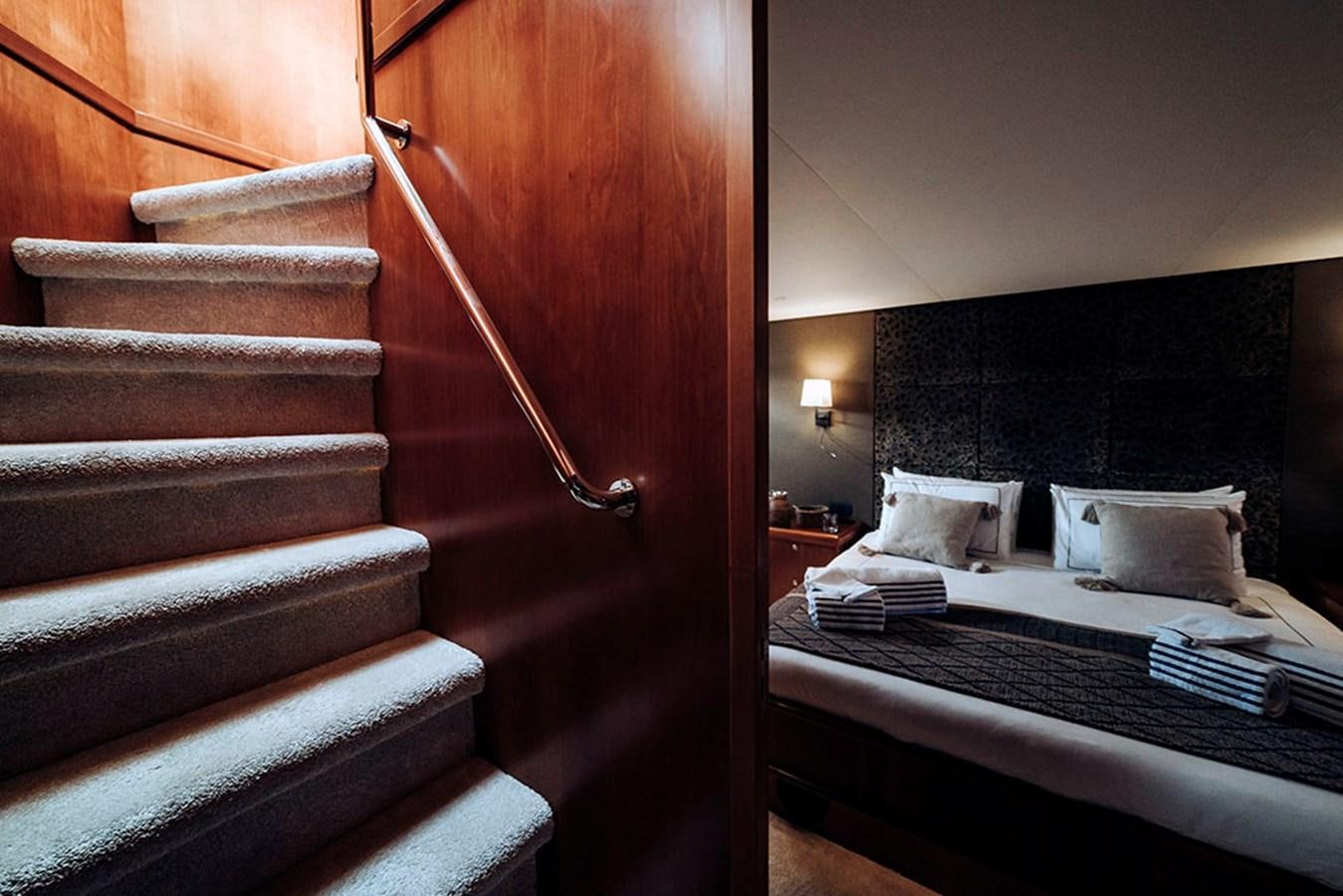 a bed with a black and white striped bed spread aboard LAS NINAS Yacht for Sale