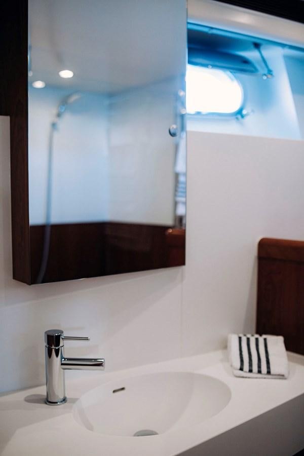 a bathroom with a sink and a mirror aboard LAS NINAS Yacht for Sale