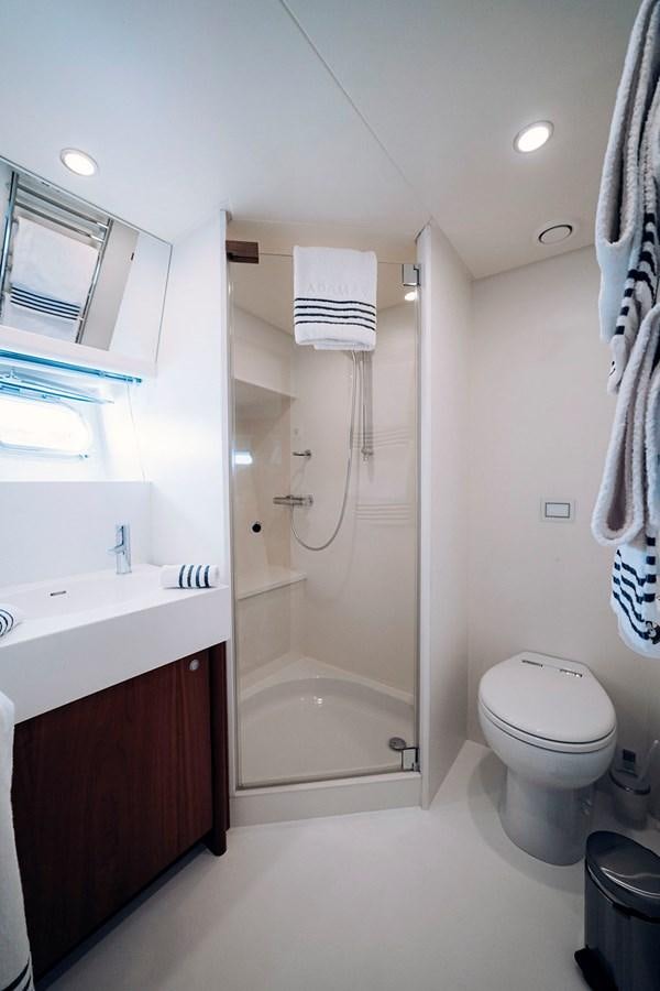a bathroom with a shower and toilet aboard LAS NINAS Yacht for Sale