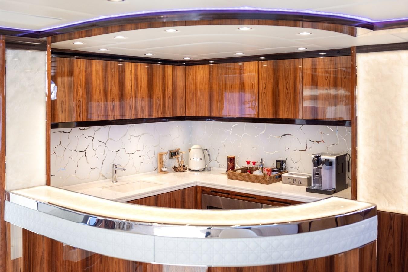 a kitchen with wooden cabinets aboard VARVARA Yacht for Sale