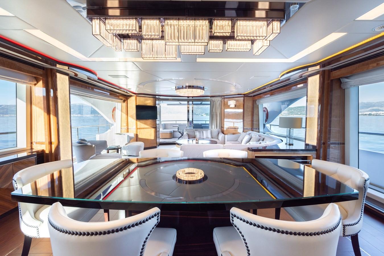 a room with a table chairs and a large window aboard VARVARA Yacht for Sale