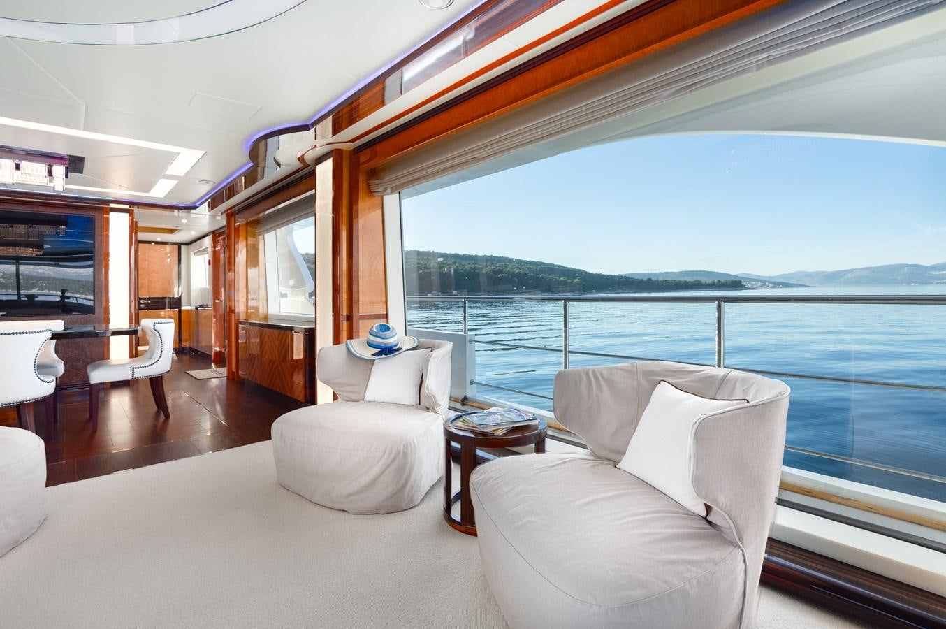 a room with a large window and a view of the water aboard VARVARA Yacht for Sale