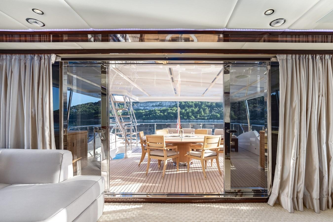 a room with a table chairs and a large window aboard VARVARA Yacht for Sale