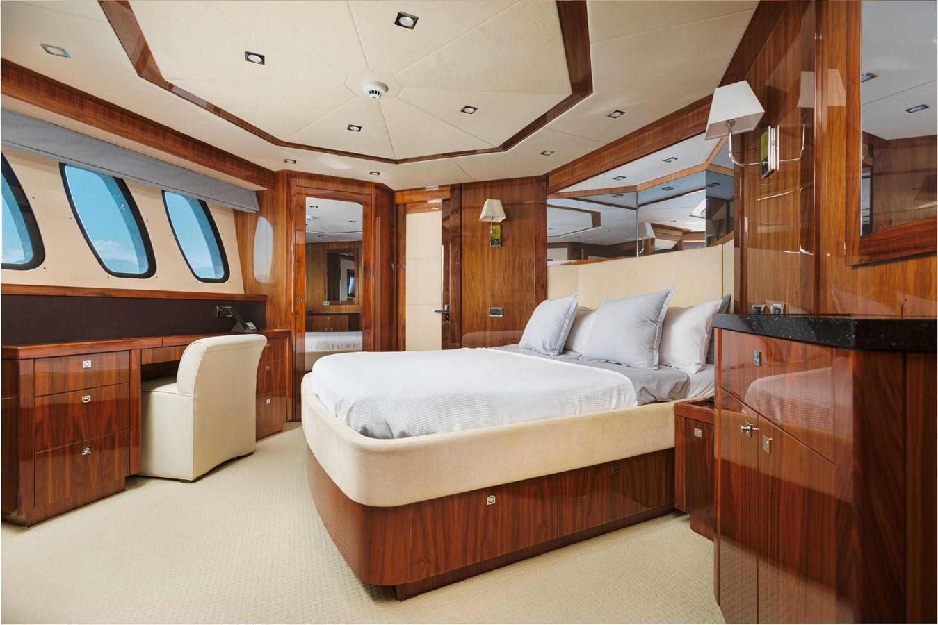 a room with a bed and a chair aboard BARRACUDA RED SEA Yacht for Sale