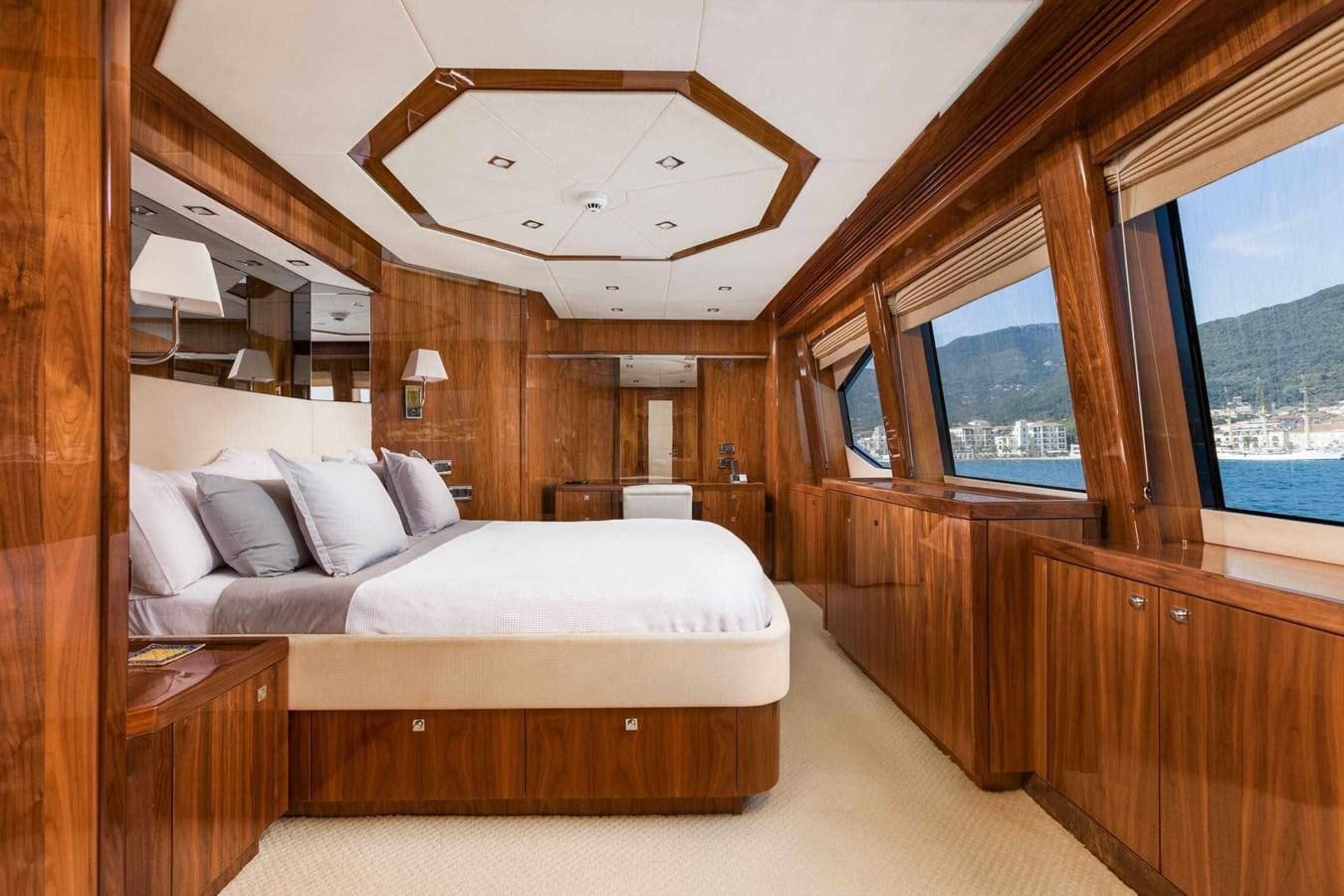 a room with a bed and a large window aboard BARRACUDA RED SEA Yacht for Sale