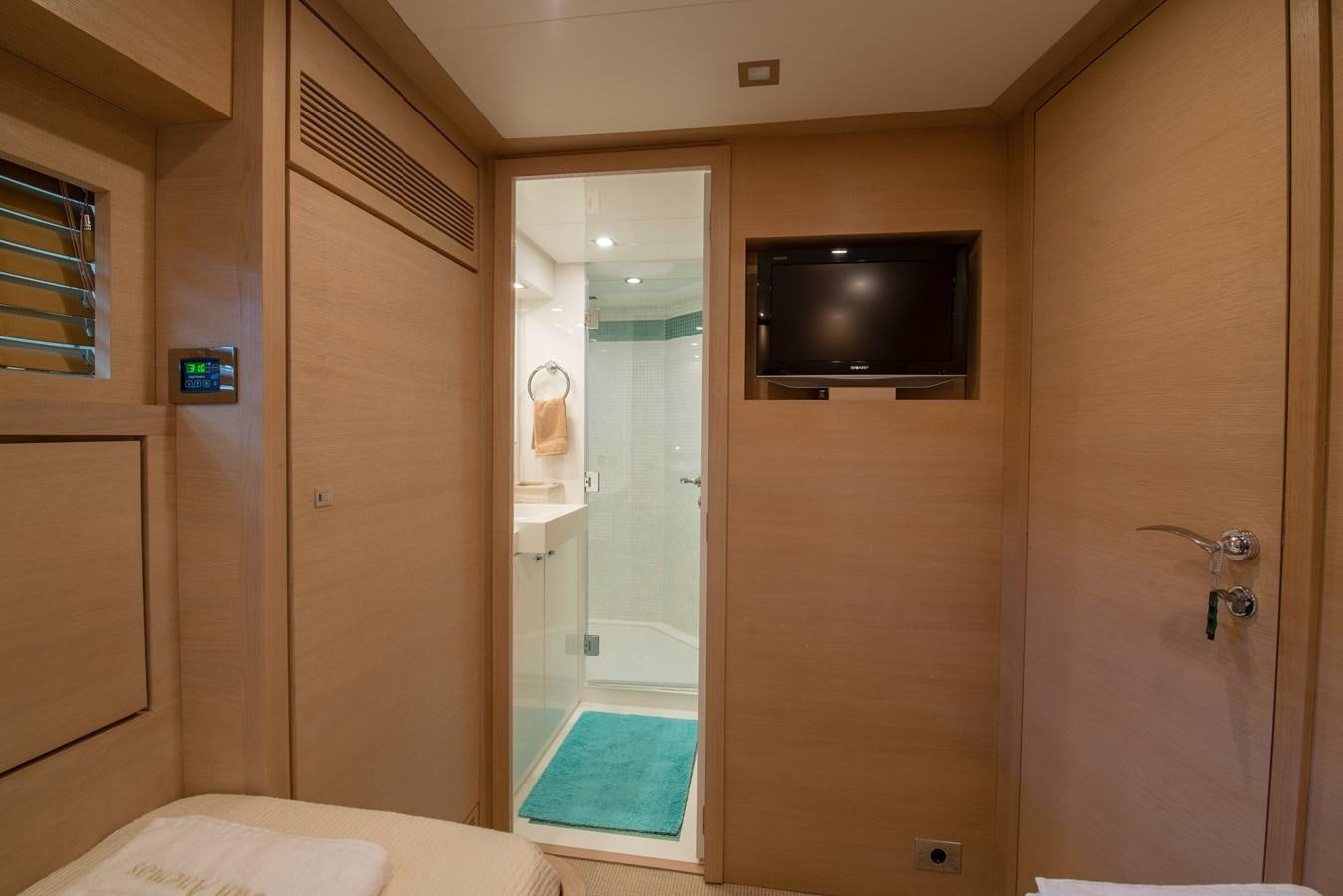 a bathroom with a tv and a shower aboard SUN ANEMOS Yacht for Sale