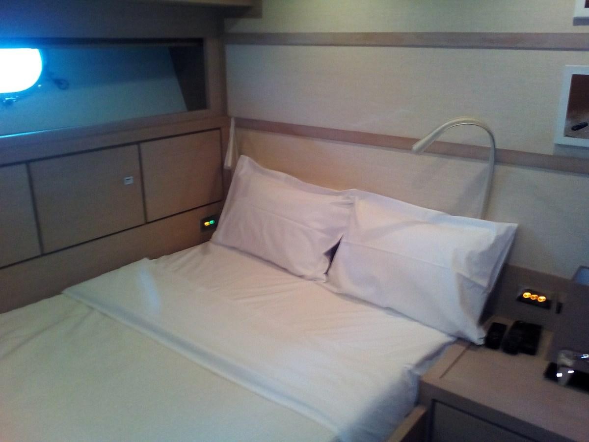 a bed with white sheets aboard SUN ANEMOS Yacht for Sale