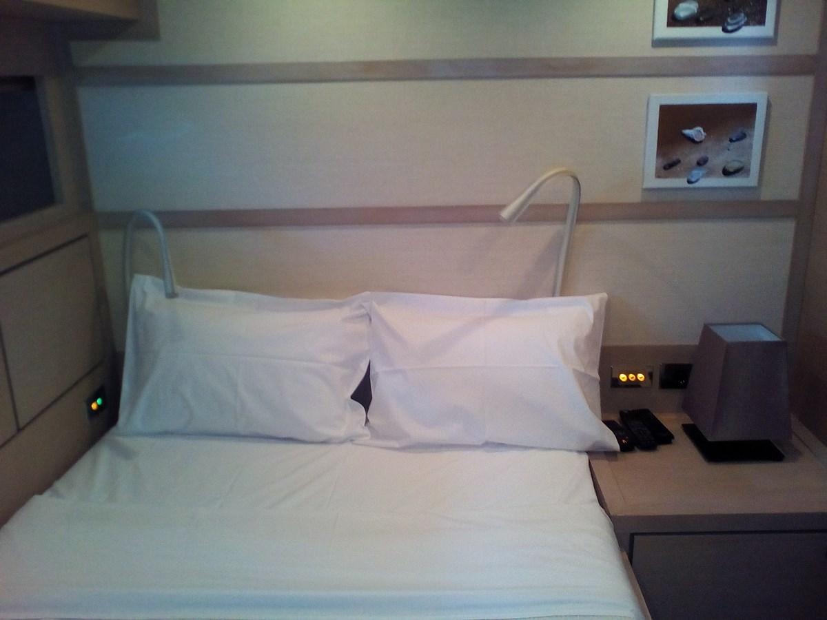 a bed with white sheets aboard SUN ANEMOS Yacht for Sale