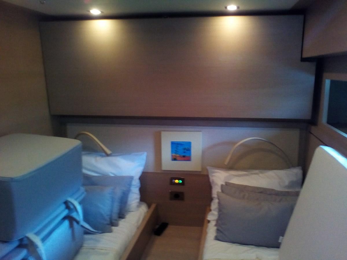 a room with a bed and a chair aboard SUN ANEMOS Yacht for Sale