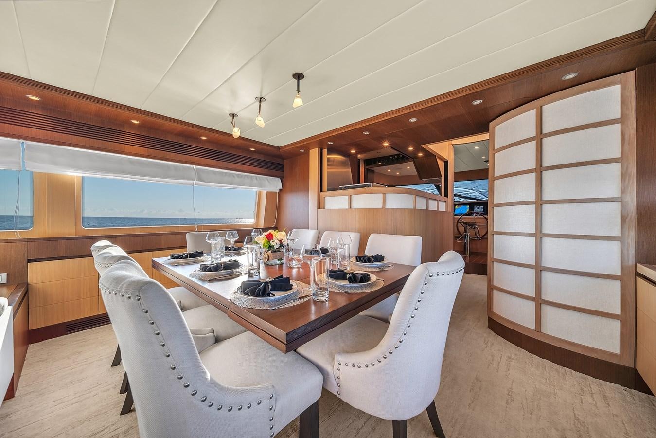 a dining table in a room aboard DOMINIC Yacht for Sale