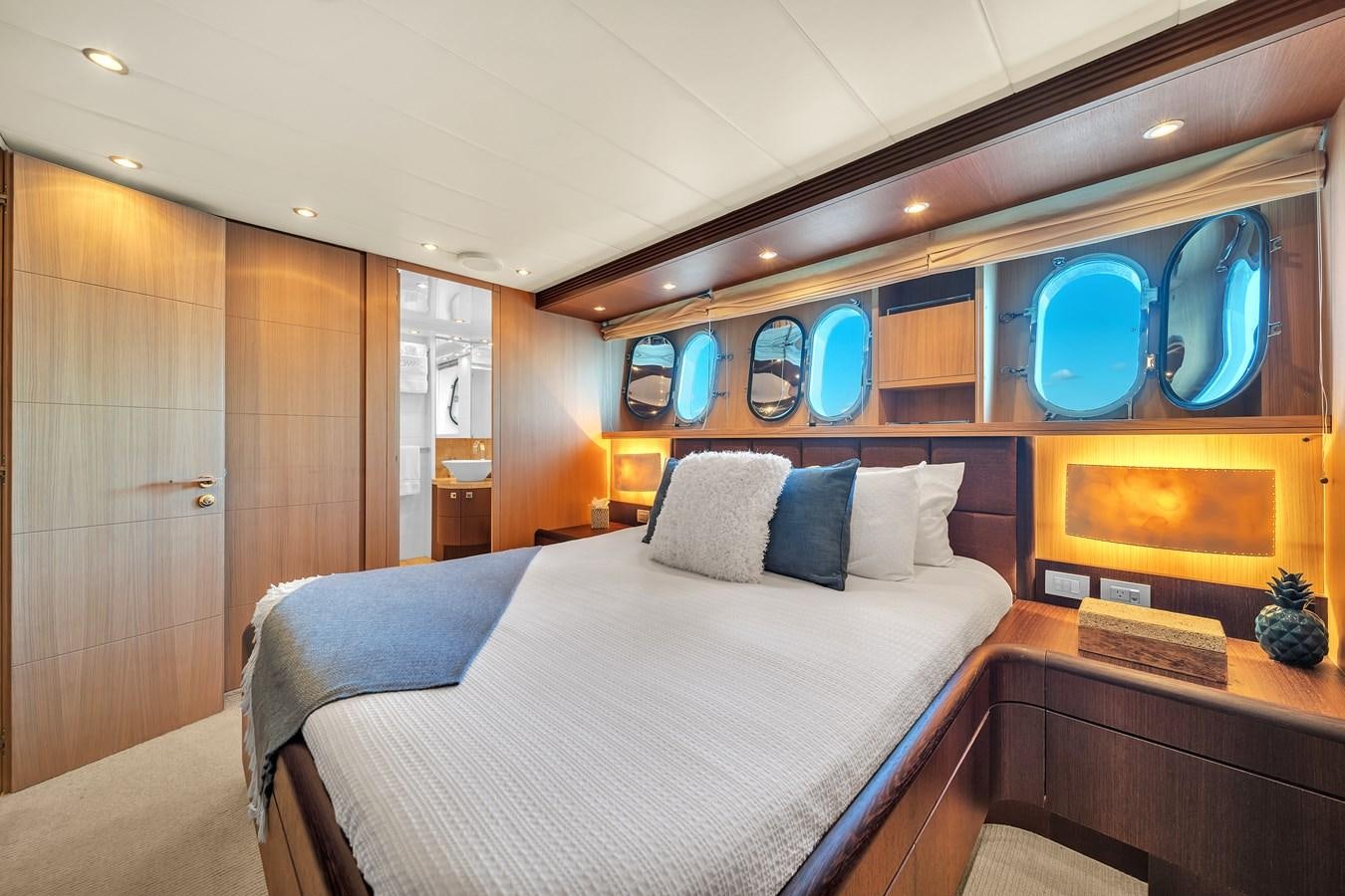 a bedroom with a bed and a mirror aboard DOMINIC Yacht for Sale