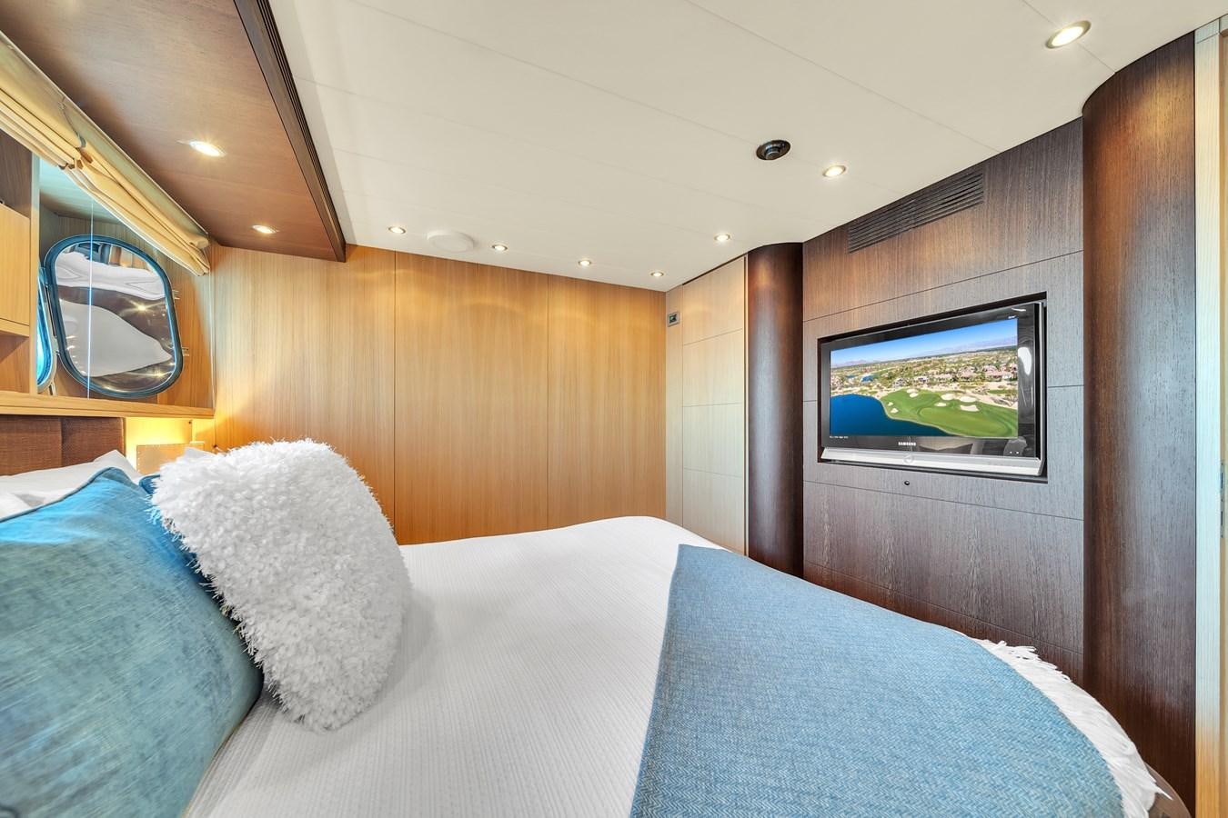 a bed with pillows and a mirror aboard DOMINIC Yacht for Sale