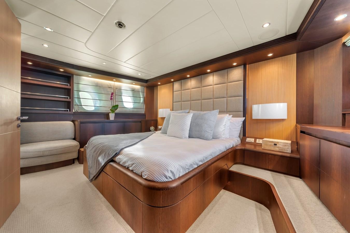 a room with a bed and a couch aboard DOMINIC Yacht for Sale