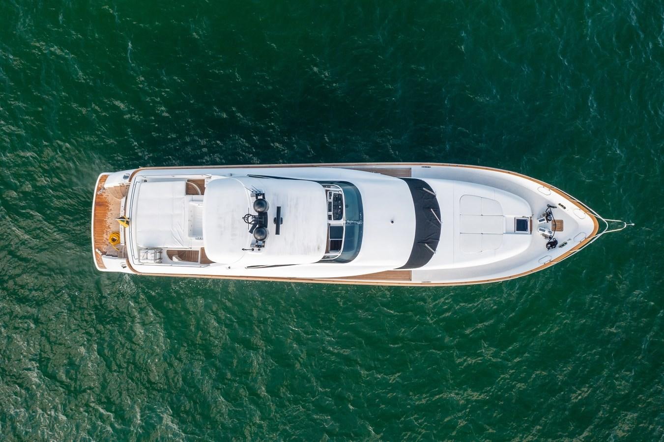 a white and gold boat on green water aboard DOMINIC Yacht for Sale