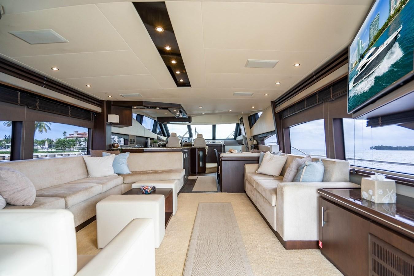 a living room with a large screen aboard MAYA Yacht for Sale