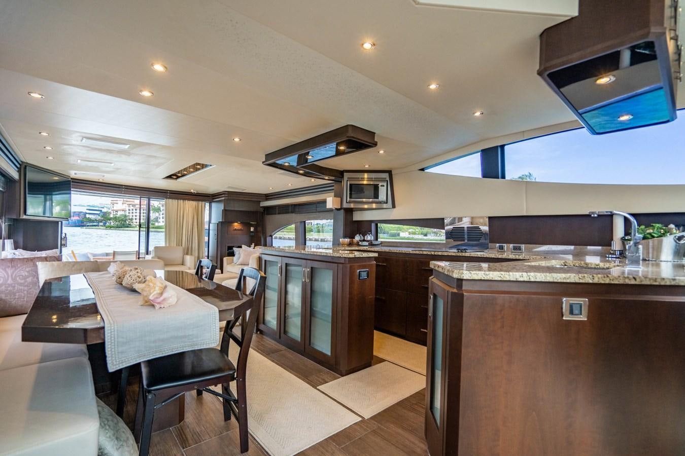 a kitchen with a table and chairs aboard MAYA Yacht for Sale