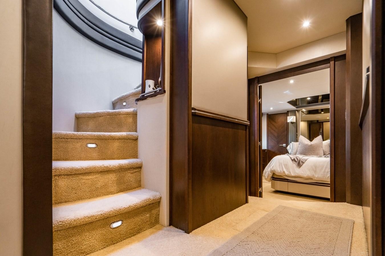 a wood staircase leading to a bedroom aboard MAYA Yacht for Sale