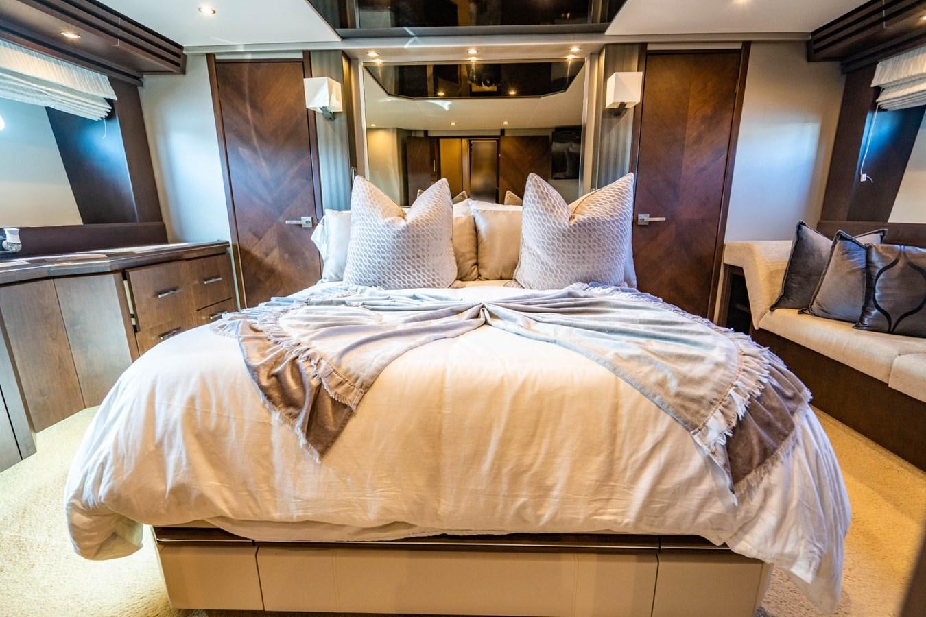 a bed with white sheets aboard MAYA Yacht for Sale