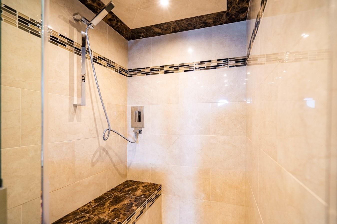 a shower with a tile floor aboard MAYA Yacht for Sale