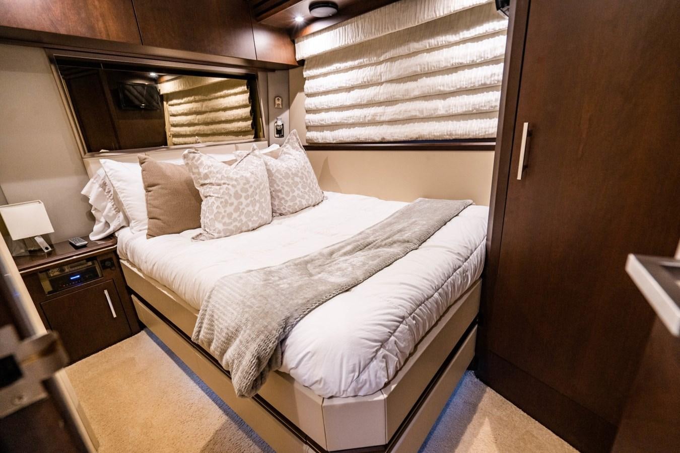 a bed with white sheets aboard MAYA Yacht for Sale