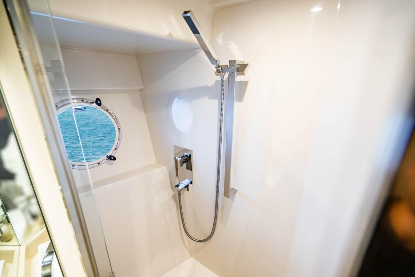 a shower with a blue round mirror aboard MAYA Yacht for Sale