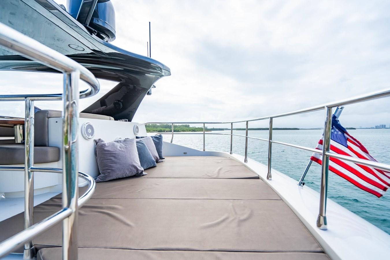 a boat with a flag on the deck aboard MAYA Yacht for Sale