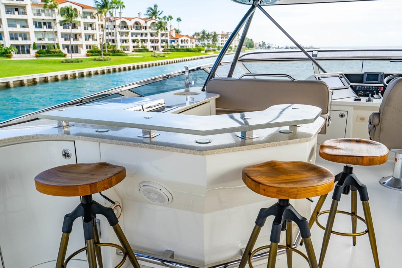 a boat with stools and stools by a pool aboard MAYA Yacht for Sale