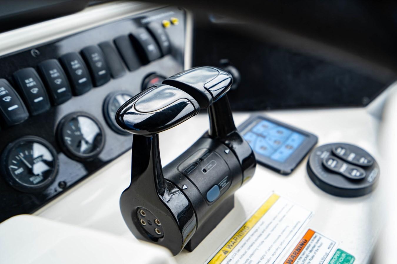 a car keychain on a table aboard MAYA Yacht for Sale