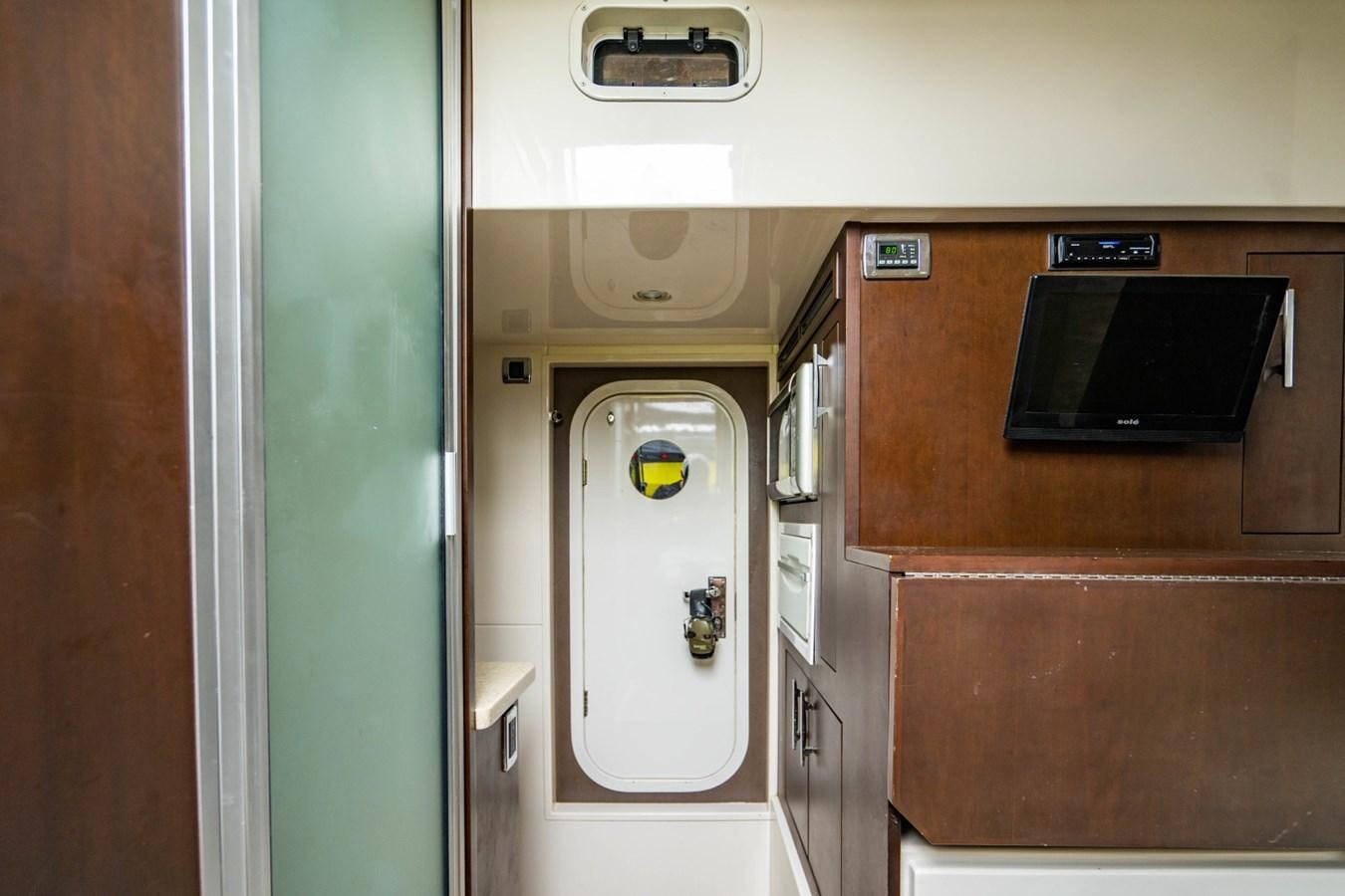 a small refrigerator in a small kitchen aboard MAYA Yacht for Sale
