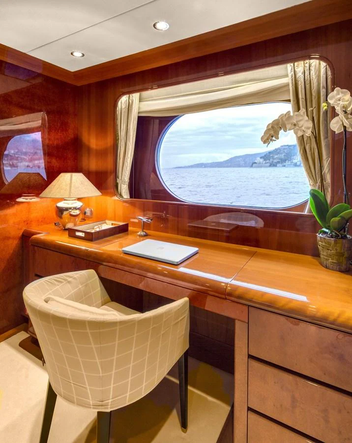 a room with a desk and a window aboard BARON TRENCK Yacht for Charter